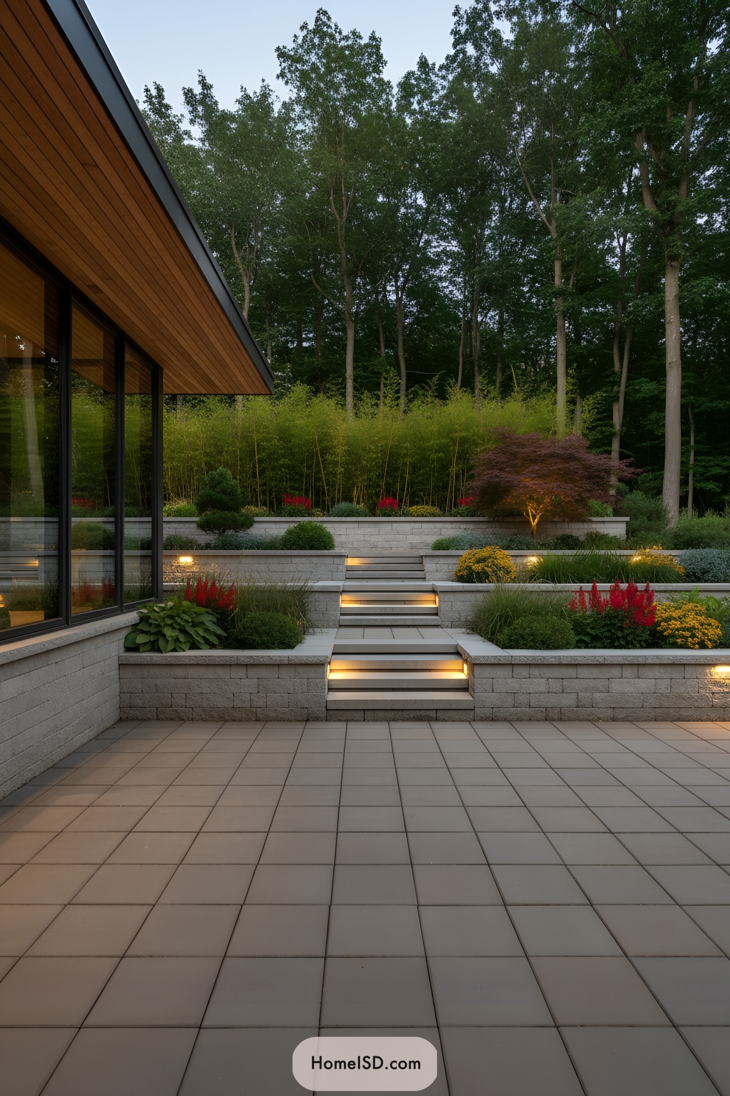 Tiered patio garden with lit steps and sculpted shrubs