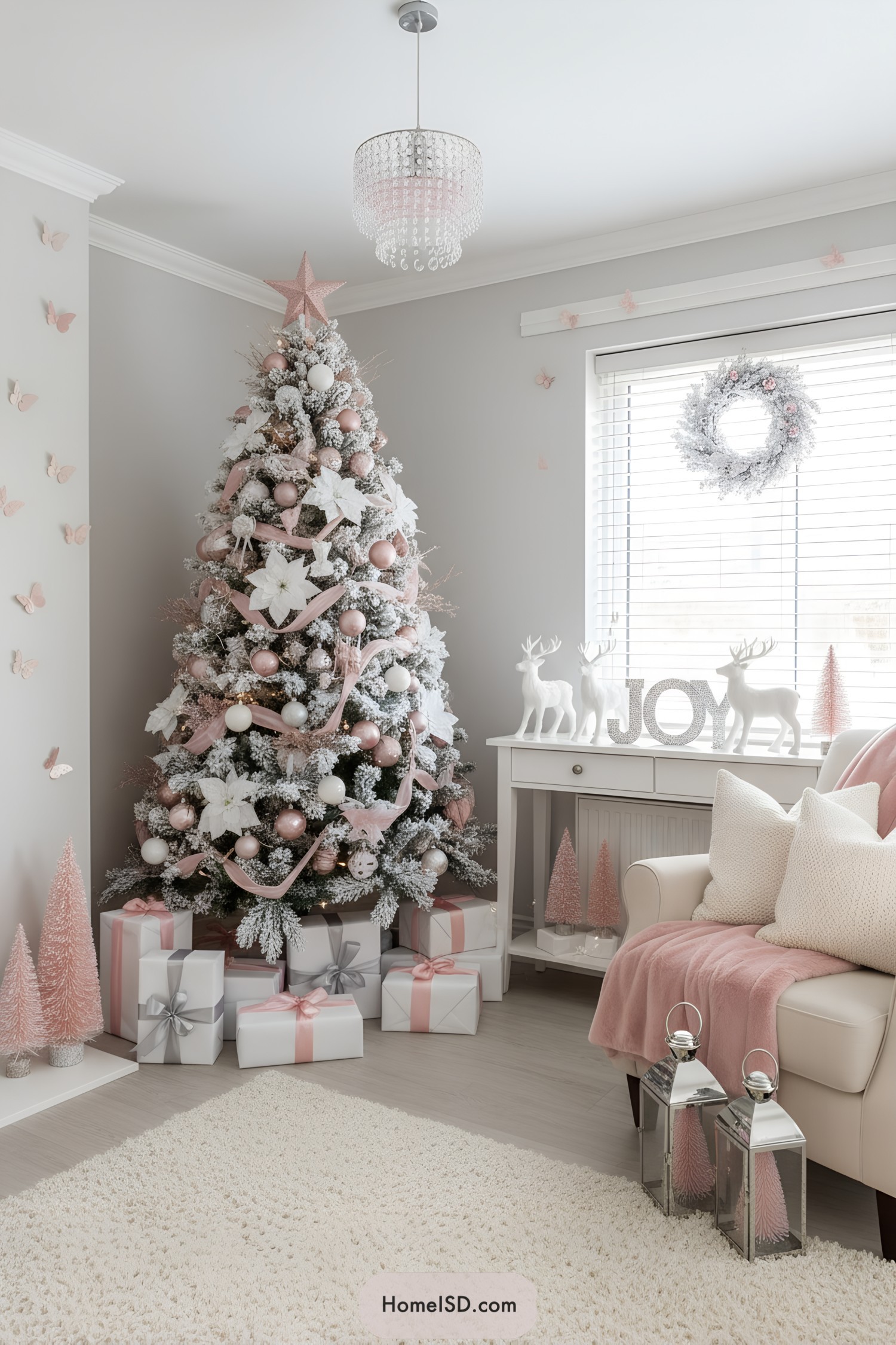 Pink-and-white frosted Christmas tree with blush ornaments, ribbons, and poinsettias