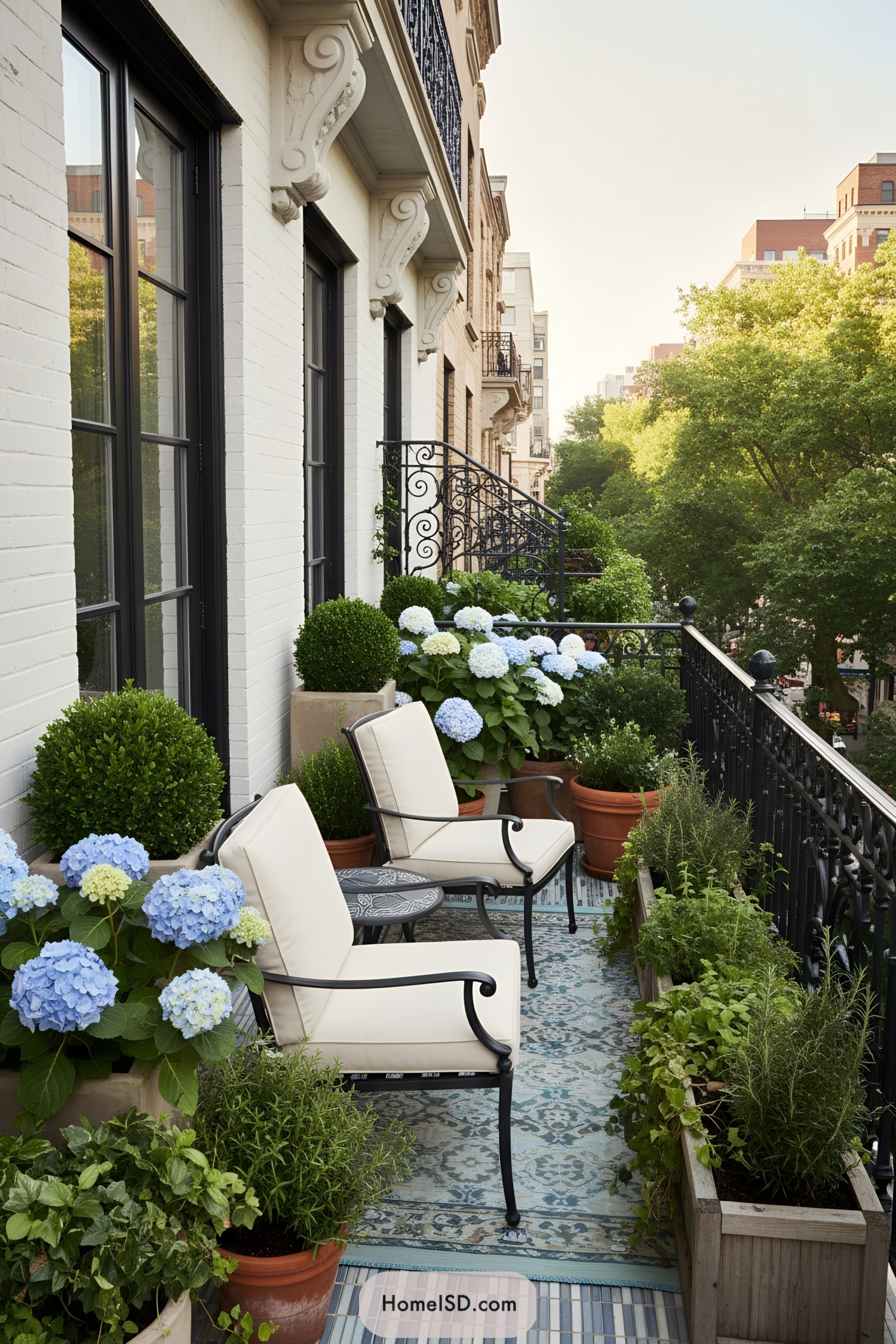 Narrow city balcony with cushioned chairs and lush hydrangea planters