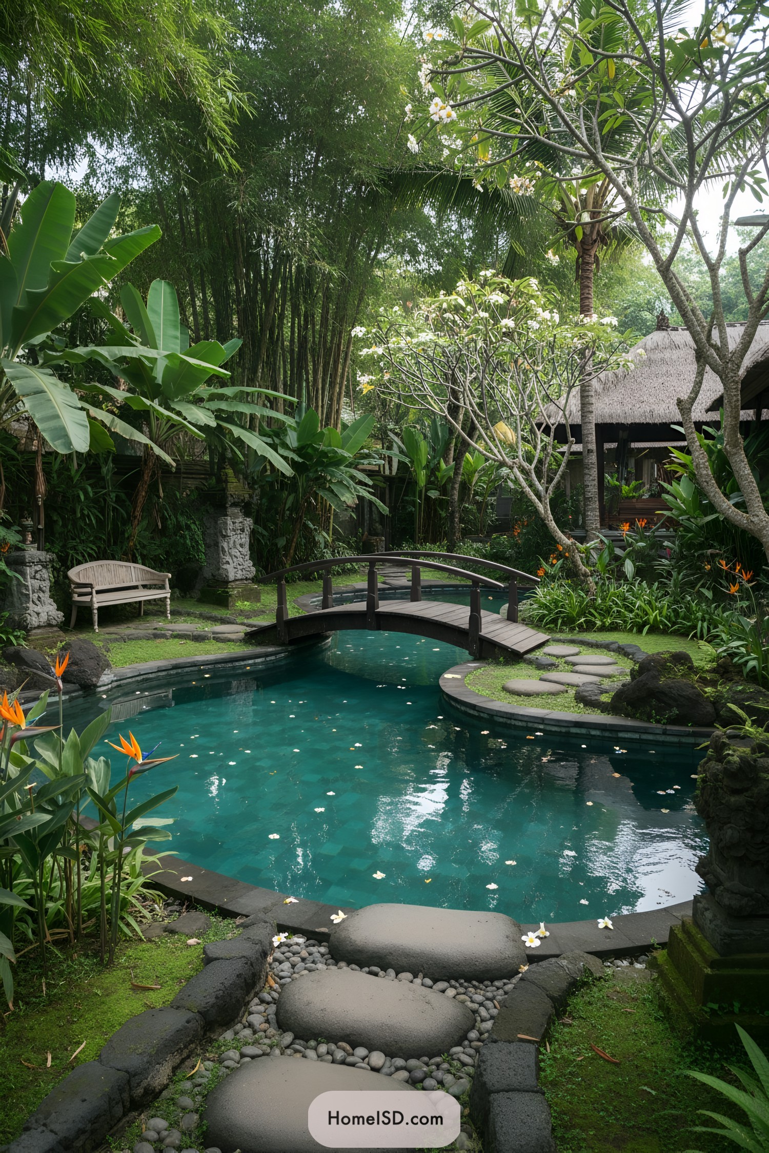 Curved pool with wooden bridge and lush greenery