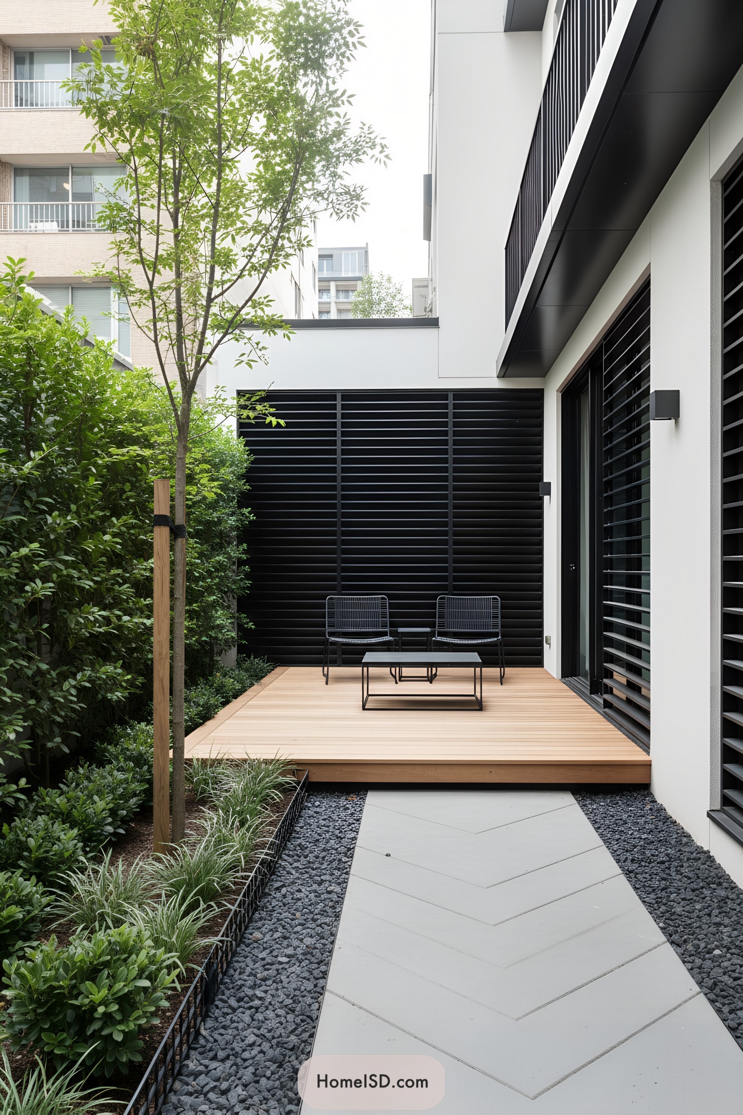 Compact modern courtyard with wood deck, black slats, and sleek seating