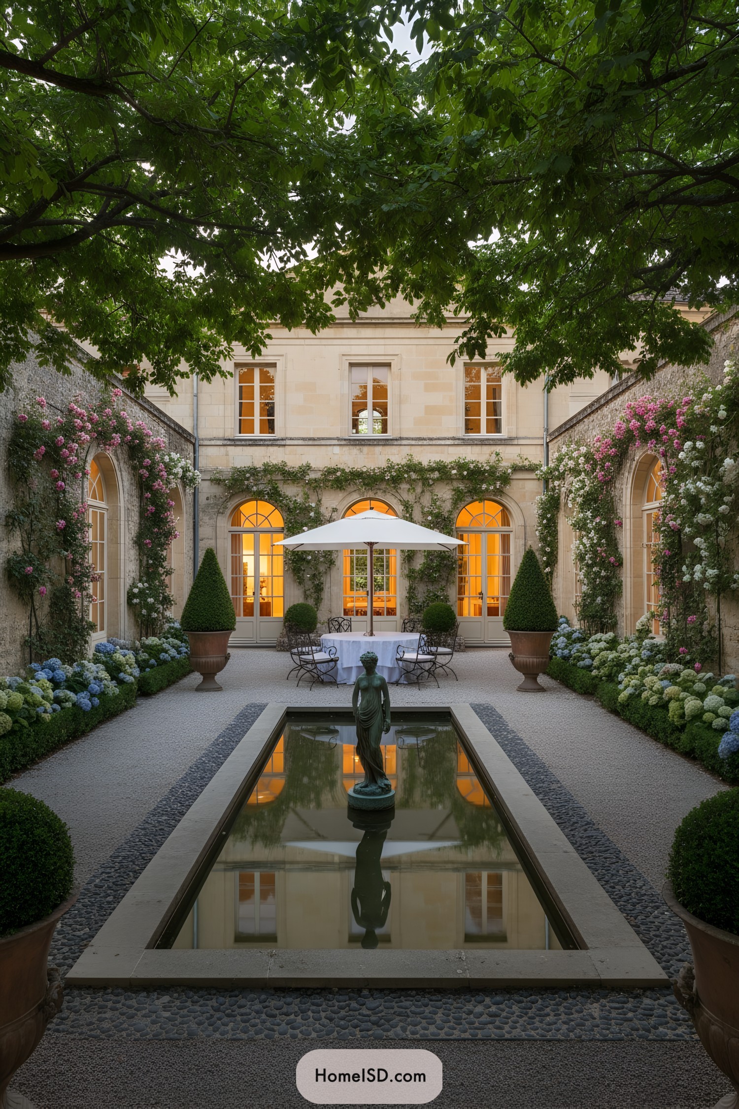 Elegant European courtyard with reflecting pool statue and dining set