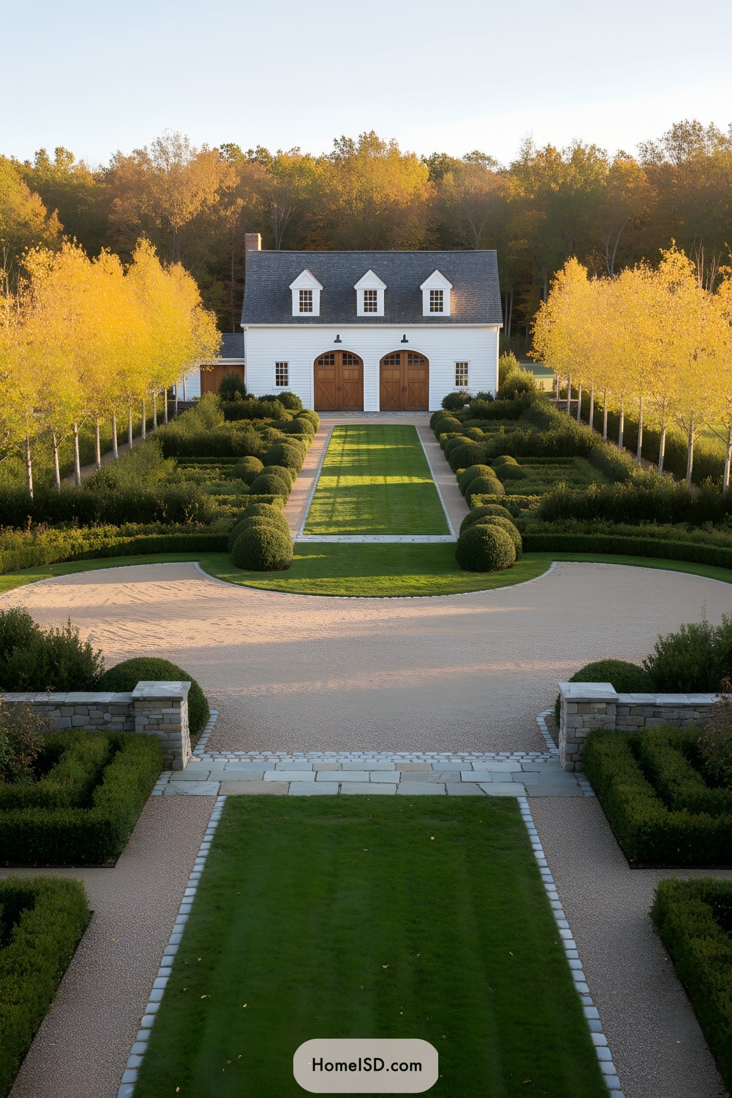 Symmetrical tree-lined lawn leading to a white carriage-style farmhouse