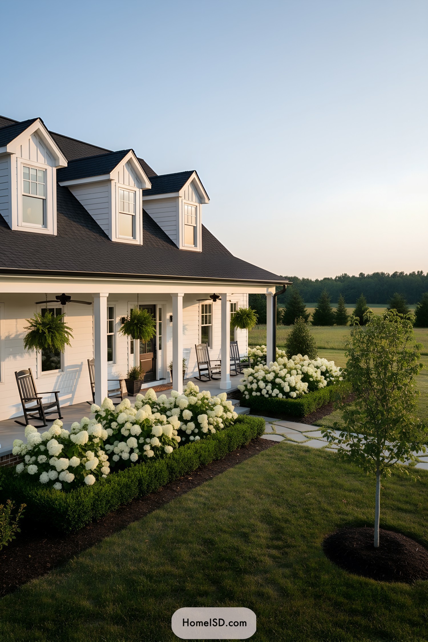 Farmhouse porch with white hydrangeas and rocking chairs