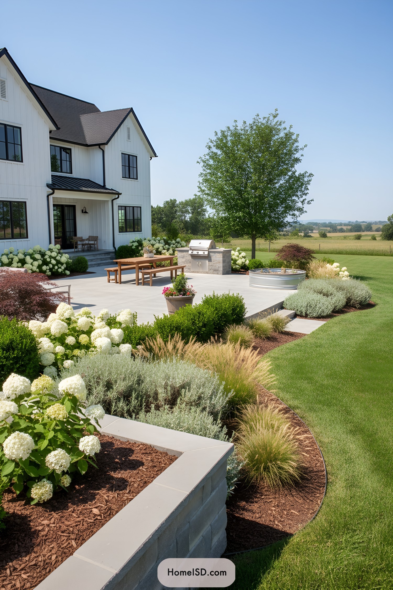 Modern farmhouse patio with layered plantings and built-in grill