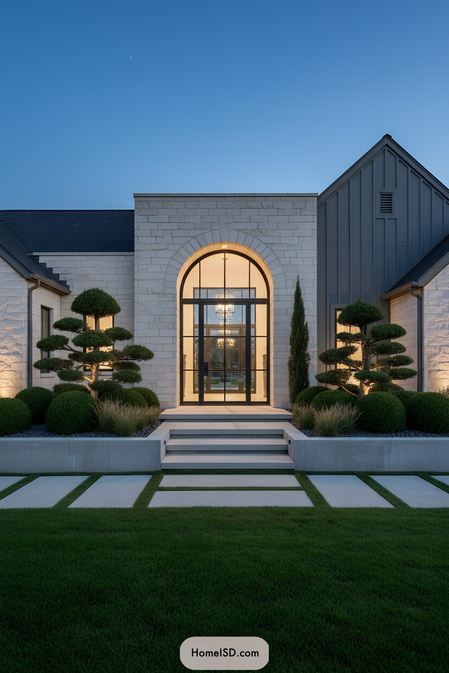 Modern entry garden with lit arched doorway