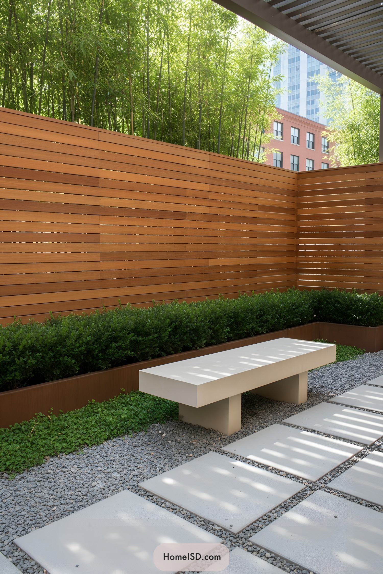 Minimalist courtyard with bamboo screen and concrete bench