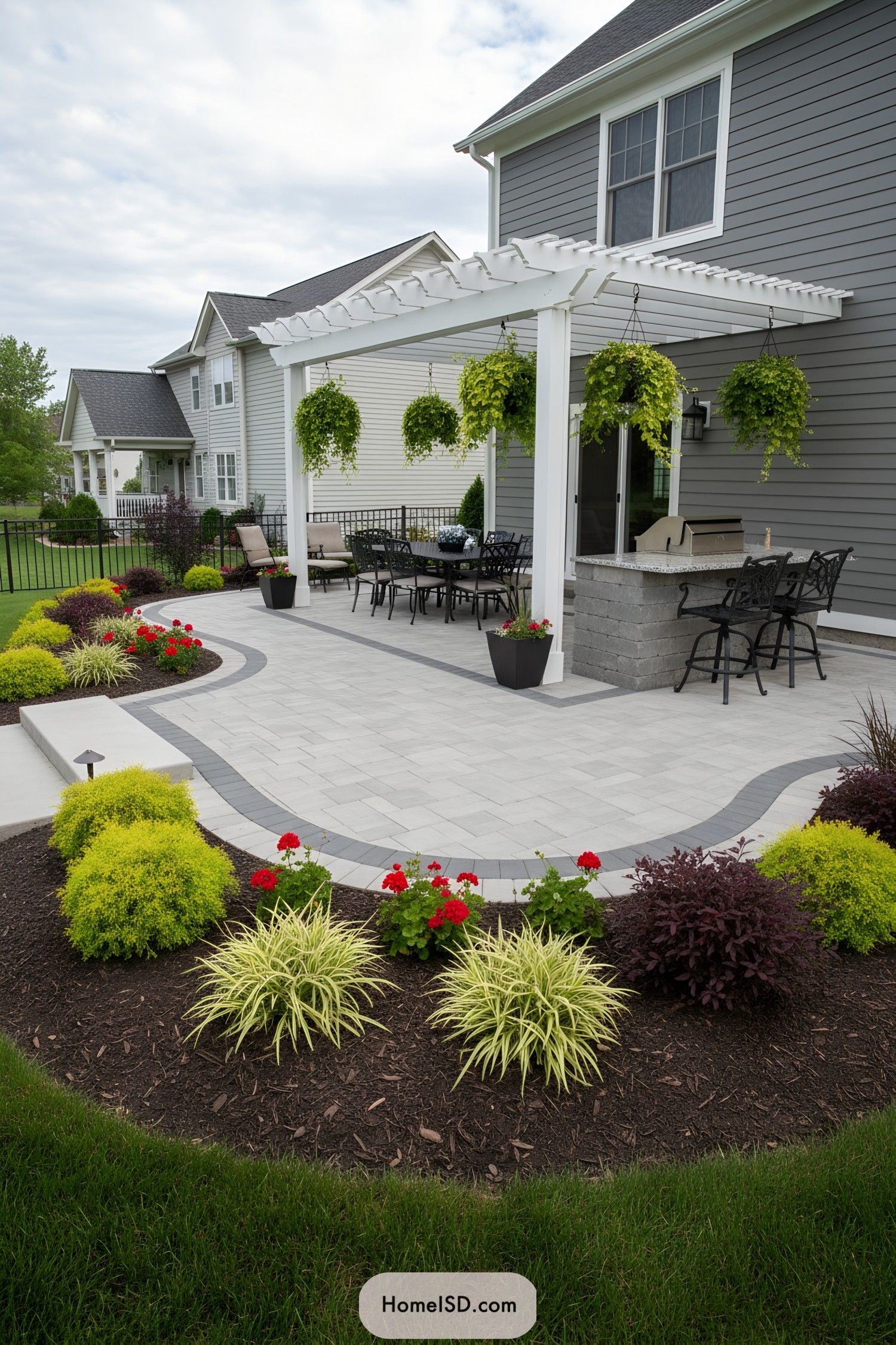 Modern backyard patio with pergola and colorful landscaping