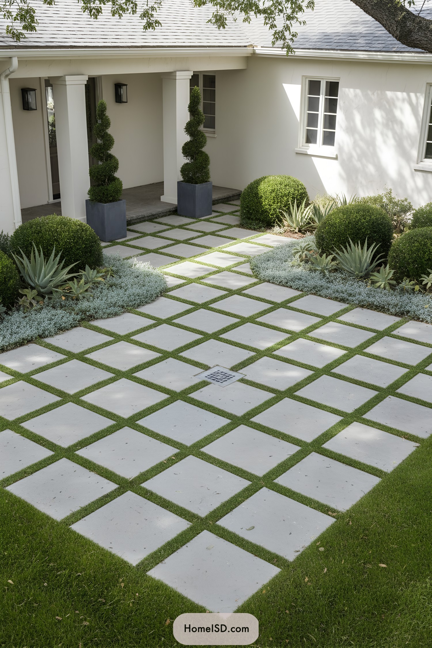 Checkerboard stone and grass front courtyard