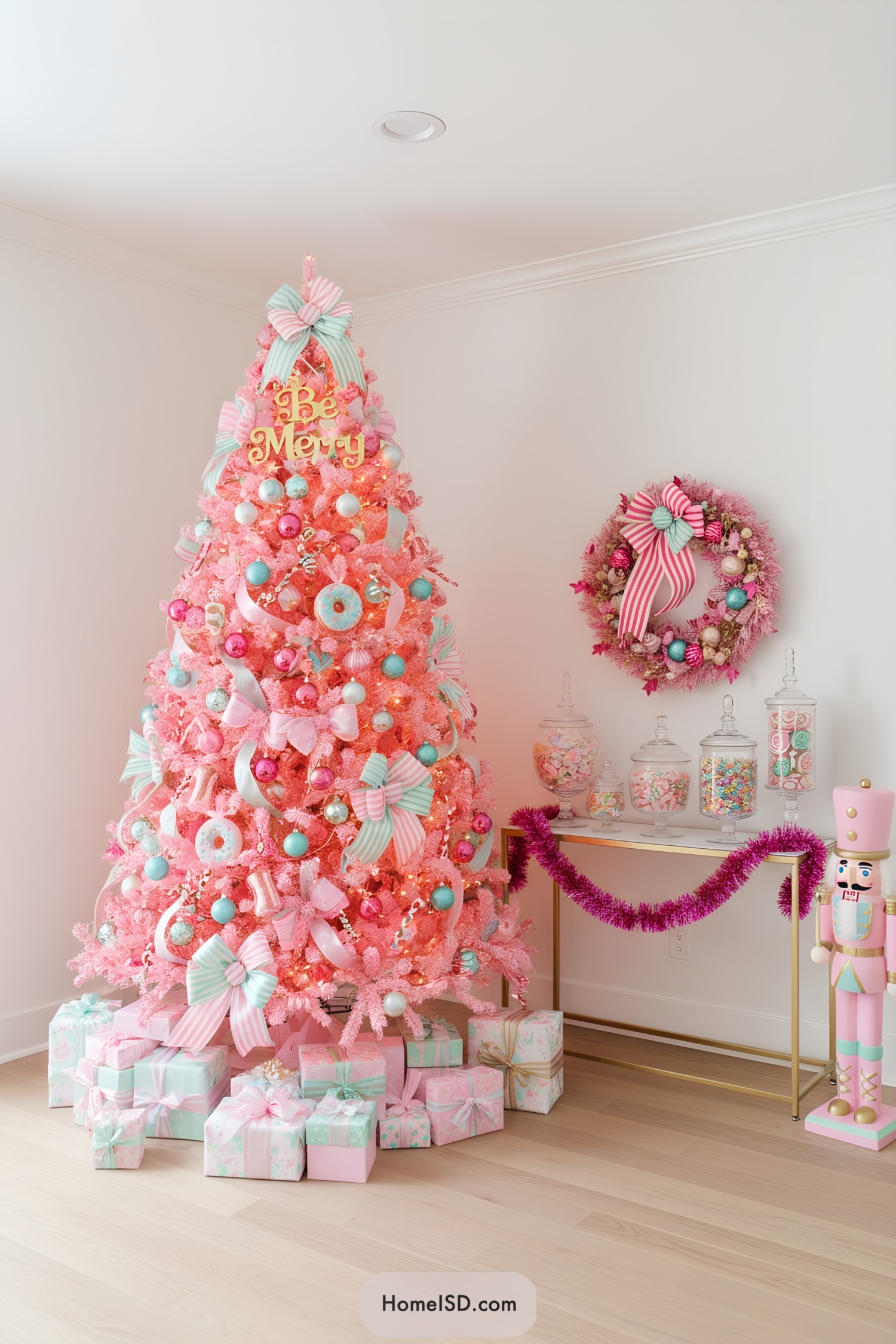 Pink Christmas tree with pastel candy ornaments and striped bows