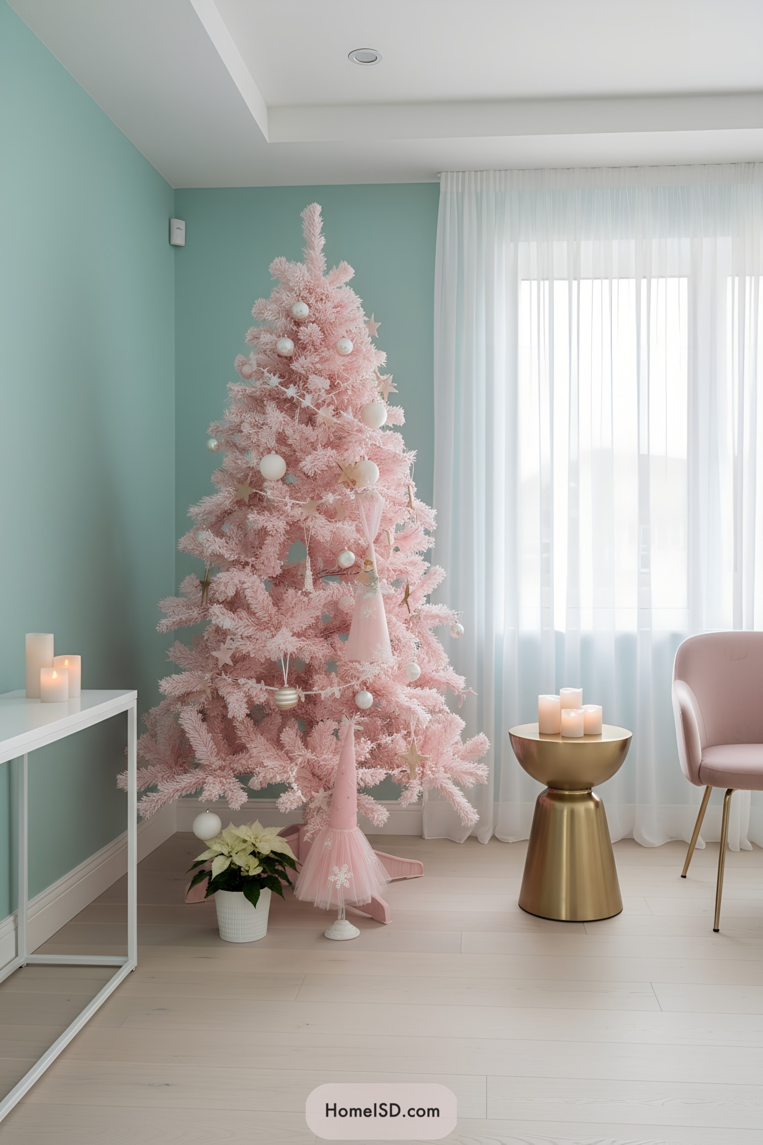 Blush pink Christmas tree with white ornaments and star garland by a window