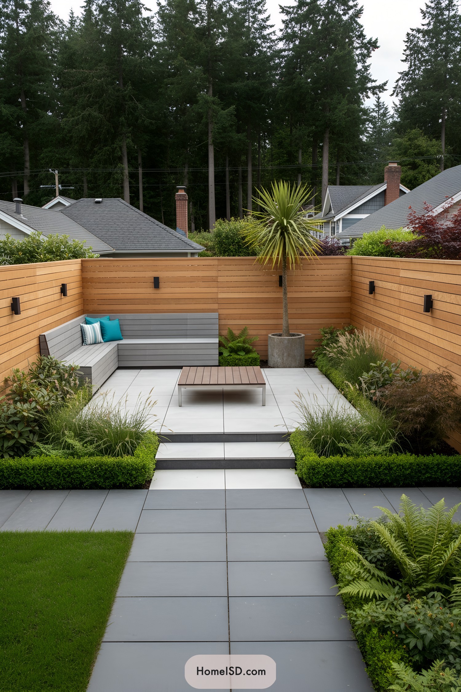 Minimalist patio with cedar privacy walls and slate pavers, built-in bench, and lush borders