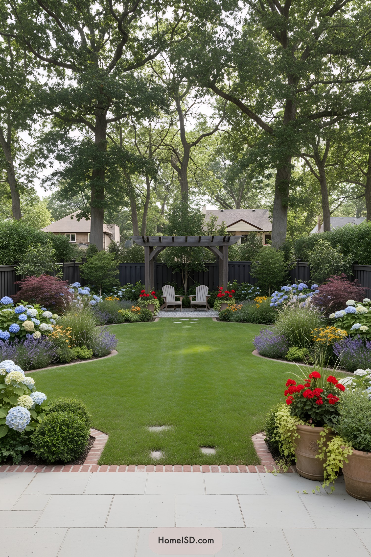 Pergola seating area framed by curved lawn and colorful flower beds
