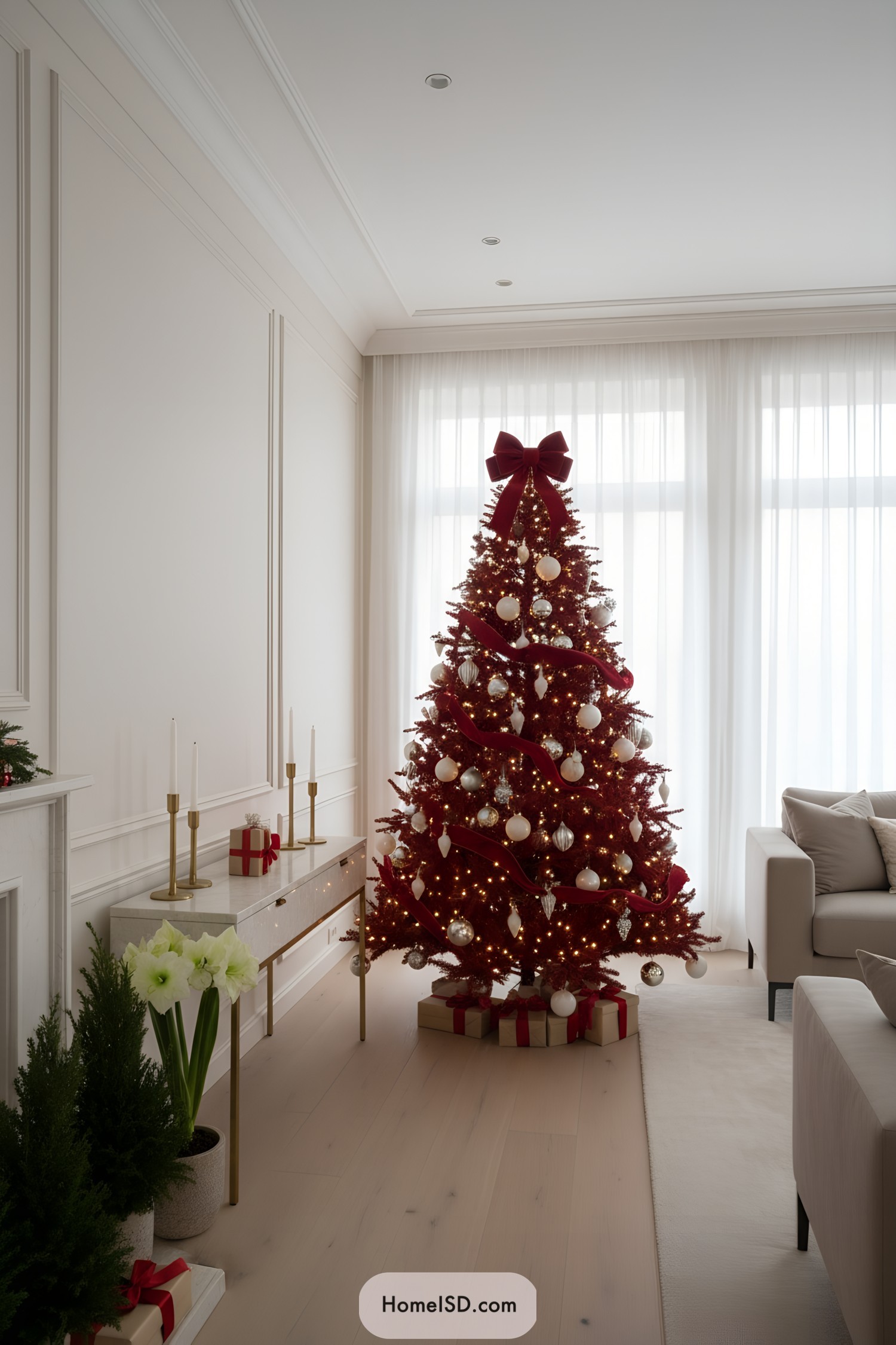Red Christmas tree with big bow, white ornaments, and warm lights