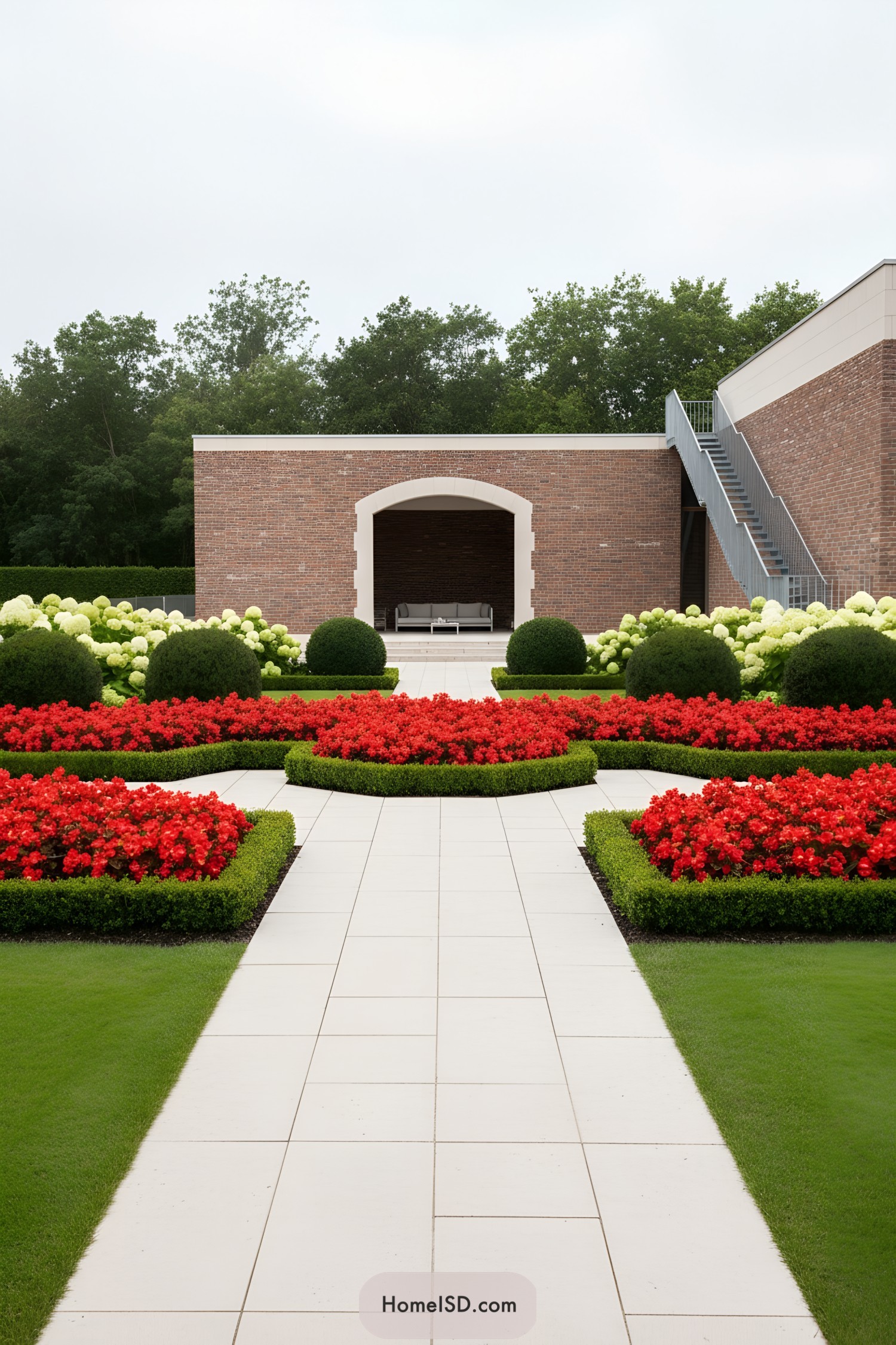 Formal garden with red flower beds and clipped hedges