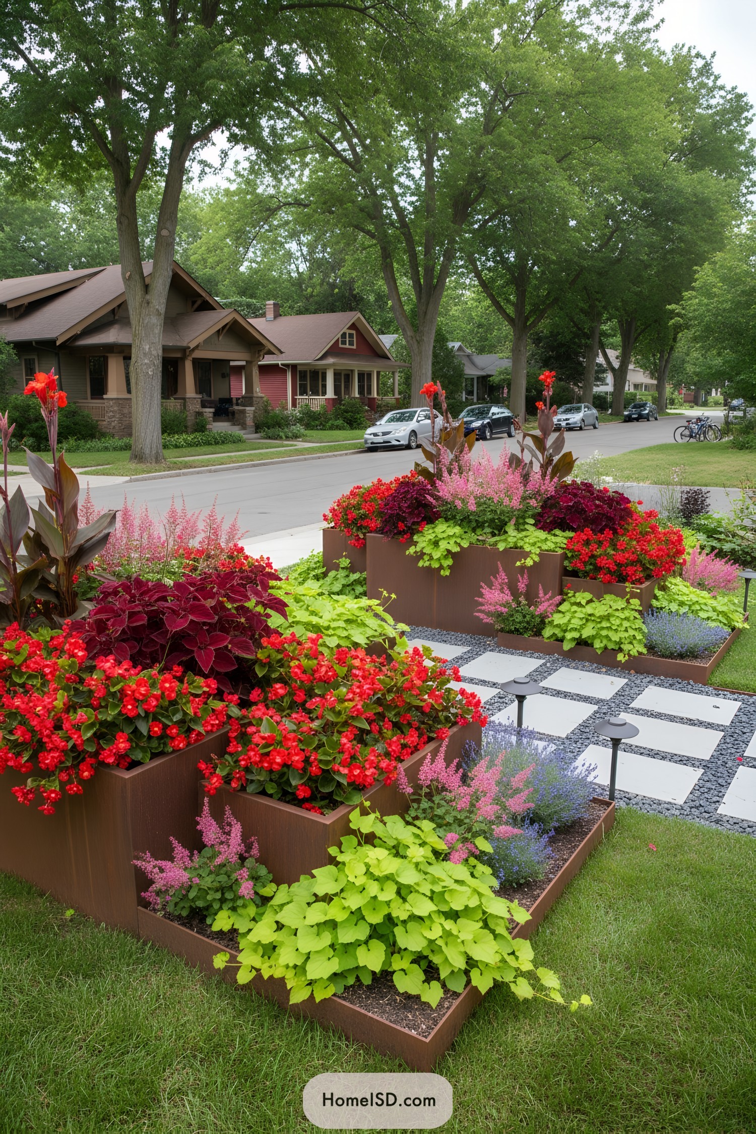 Tiered red flower planters by sidewalk