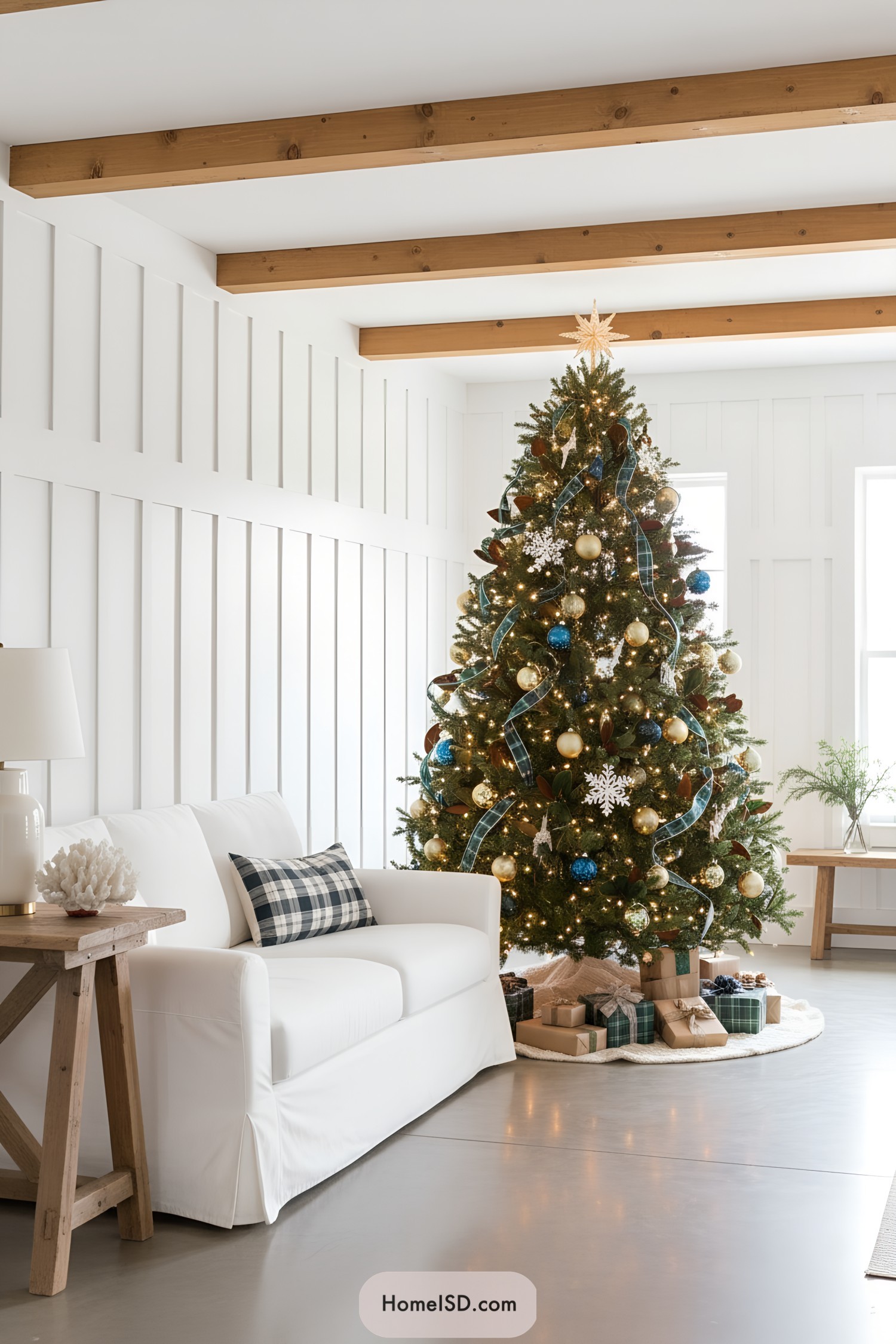 Classic tree with blue-and-gold ornaments, plaid ribbon, and twinkle lights