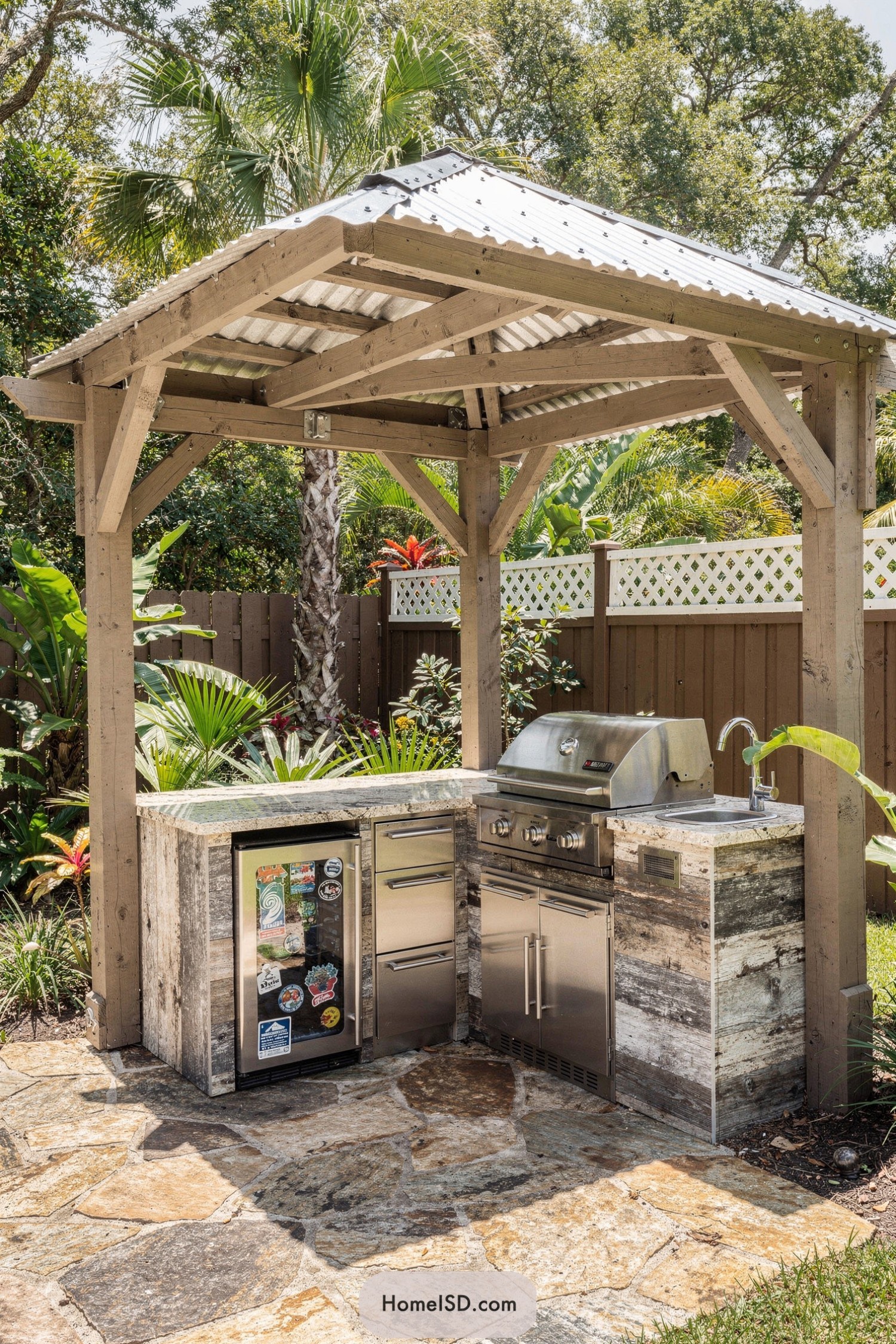 Rustic pergola with metal roof over compact outdoor kitchen grill and fridge