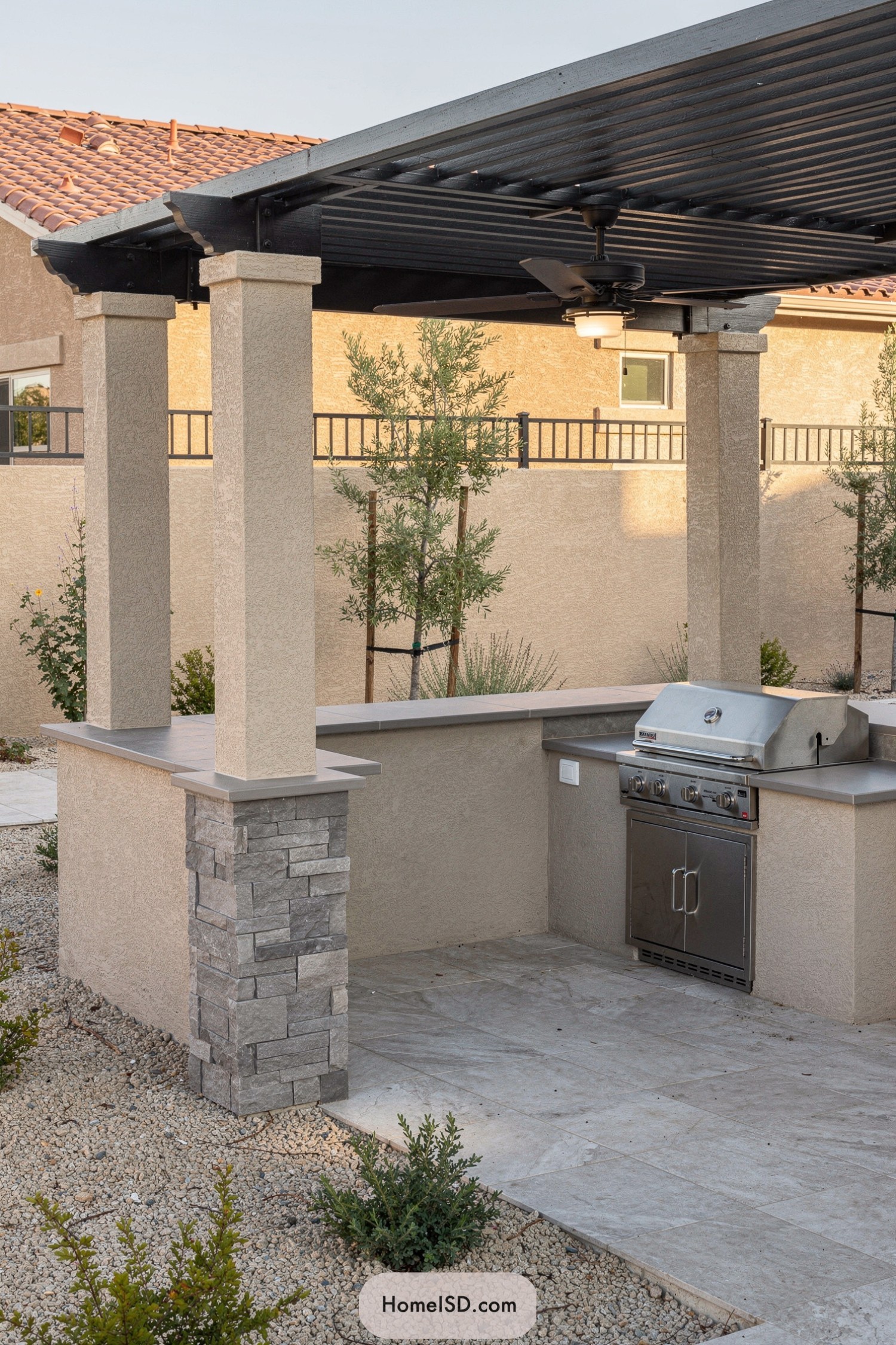 Covered outdoor grill under stucco pergola