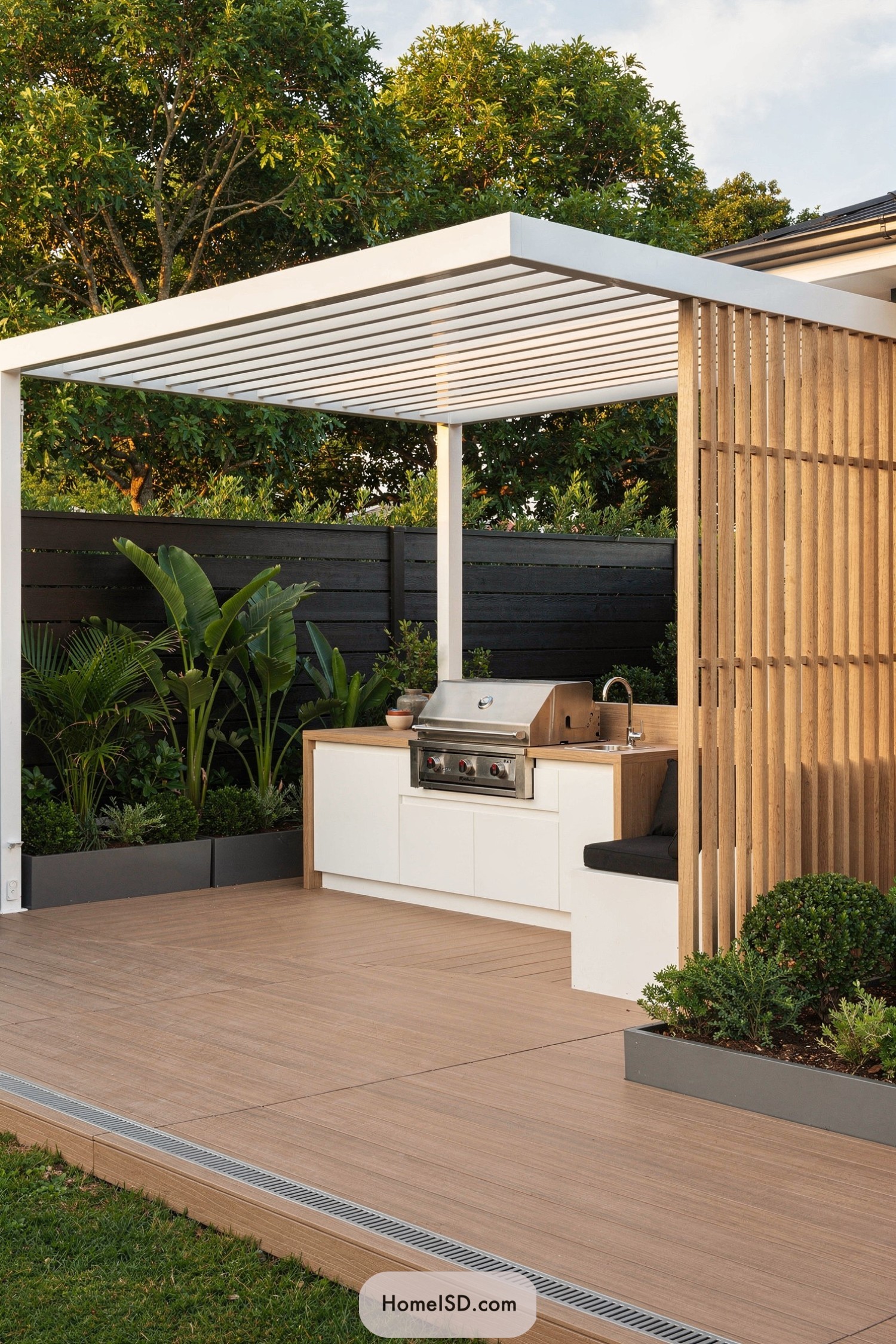 Modern white pergola with built-in outdoor grill and seating