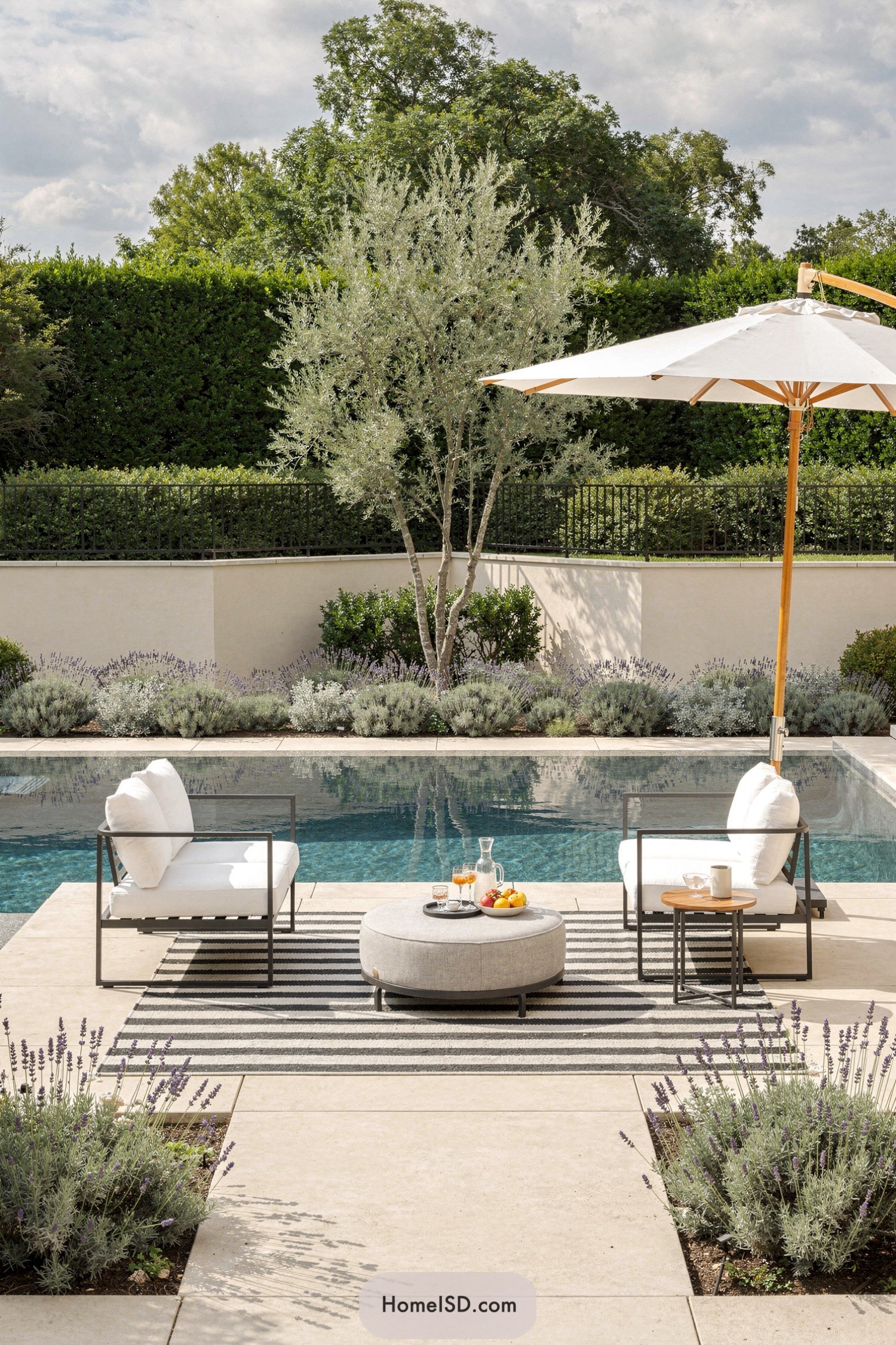 Modern poolside patio with lounge chairs, umbrella, and layered lavender borders around a rectangular pool