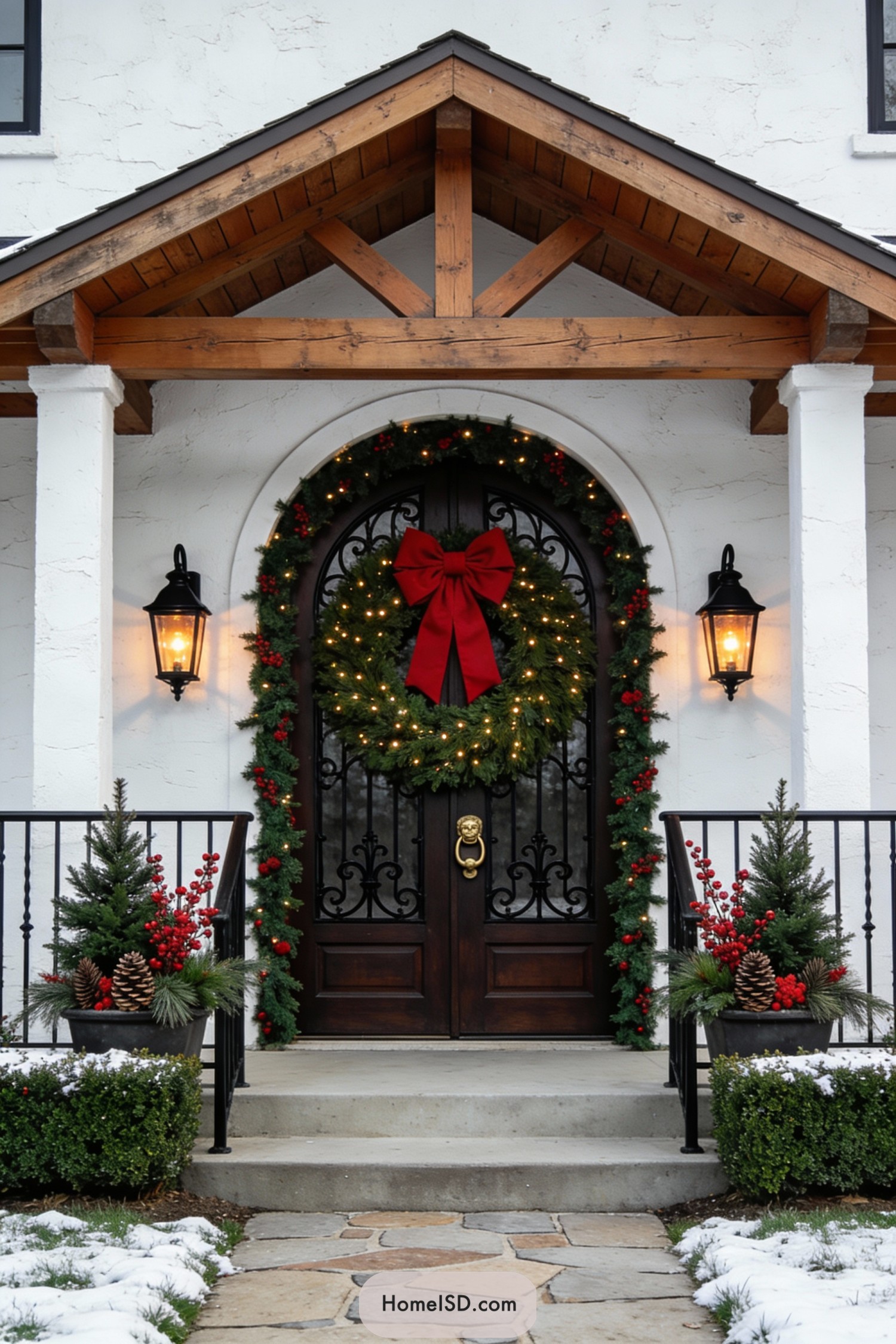 Festive front door with oversized wreath and lit garland