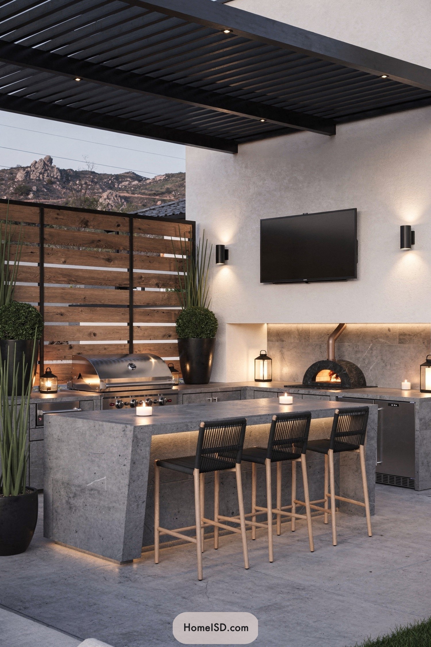 Modern outdoor kitchen with concrete bar seating and built-in grill