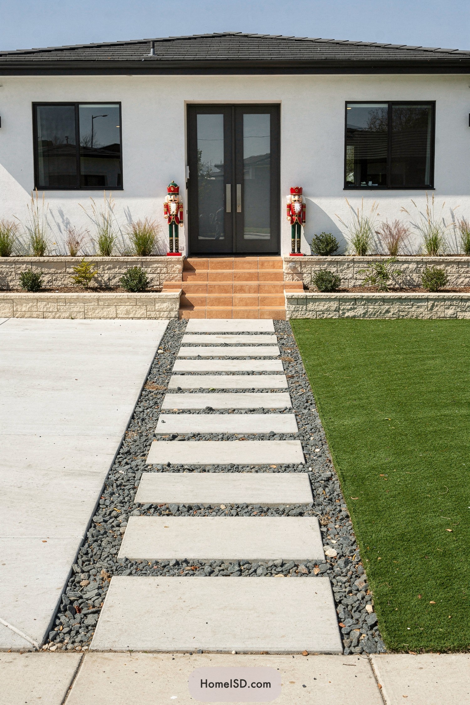 Modern front yard with stepping stone path beside artificial turf