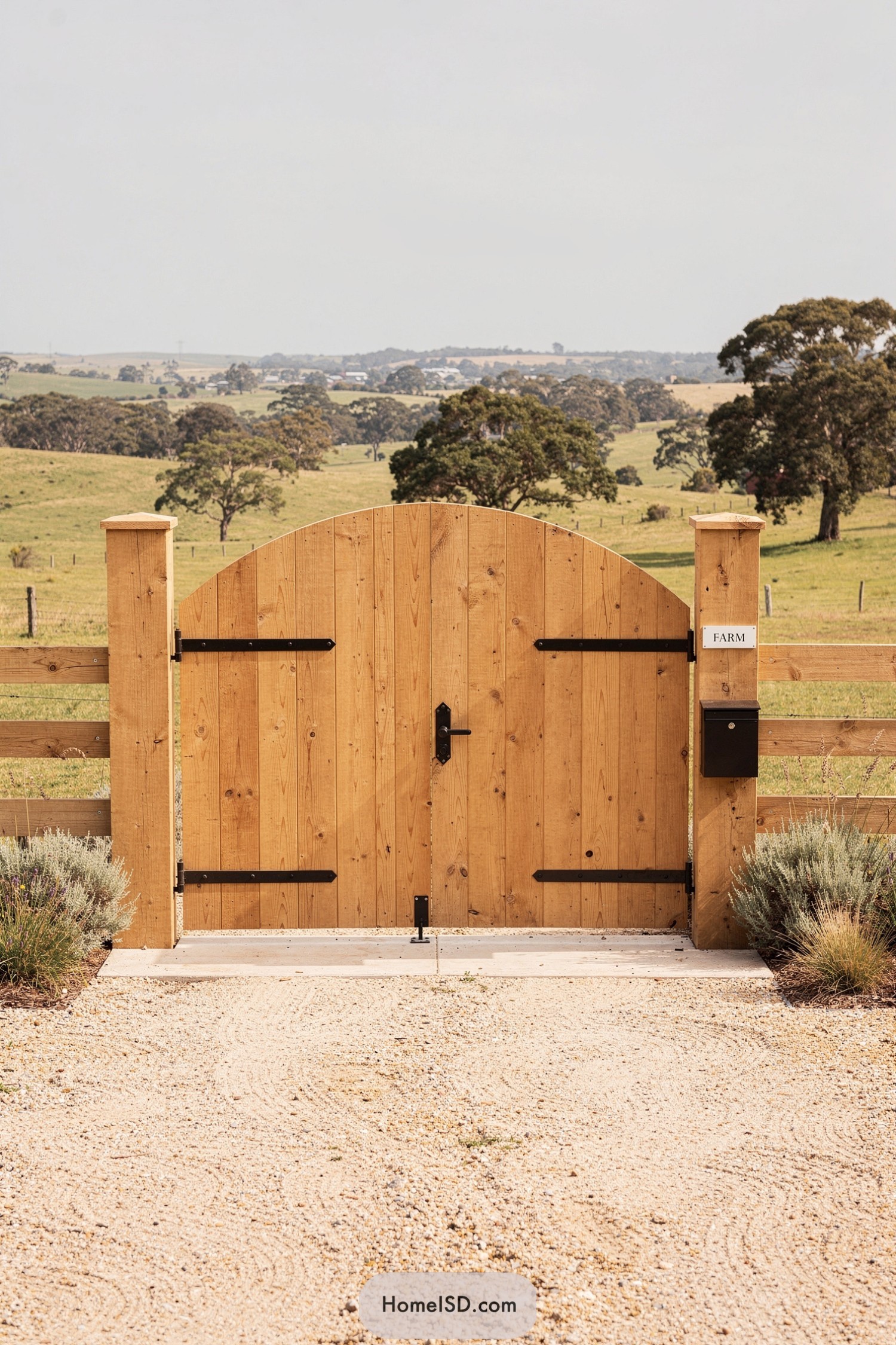 Simple arched wooden farm gate with black hardware