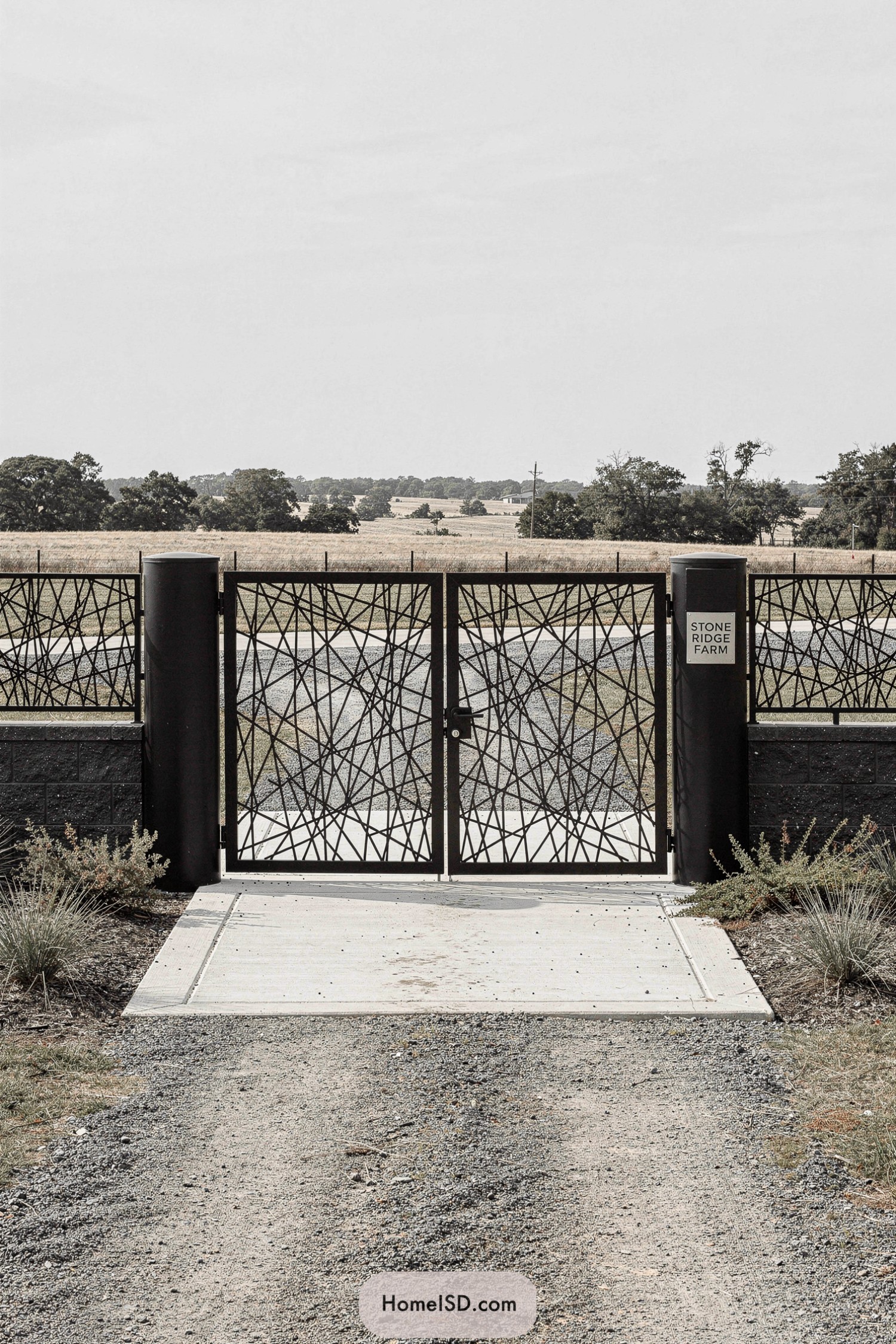 Modern metal farm gate with abstract lattice