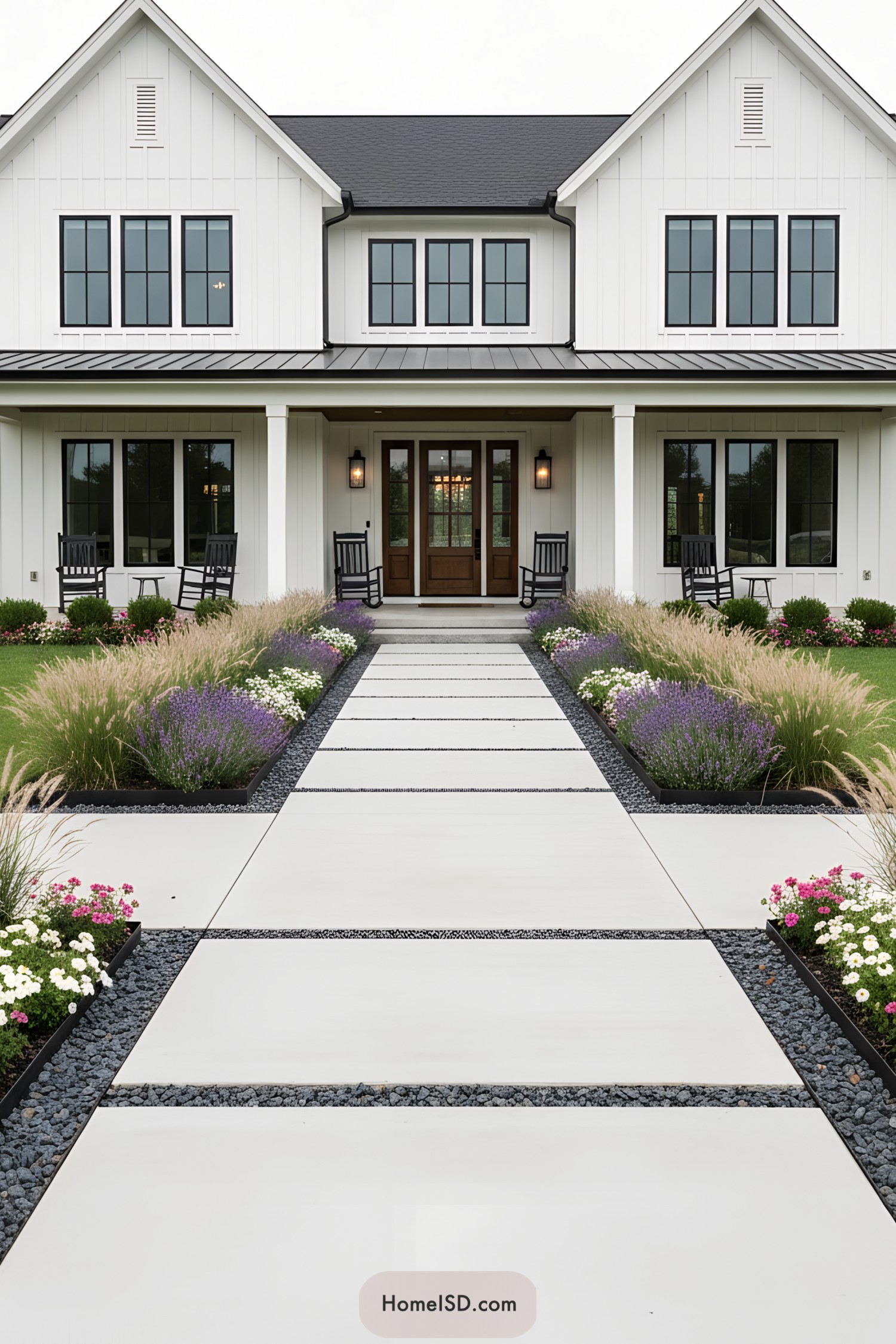 Modern farmhouse front walk with large pavers flanked by grasses and flowering borders