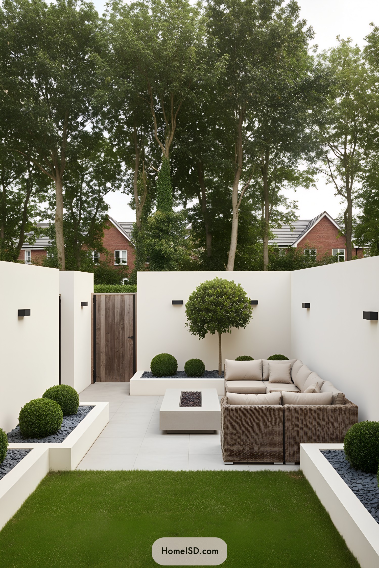 Minimalist walled courtyard with boxwood planters, trim lawn, and sectional sofa around a linear fire pit
