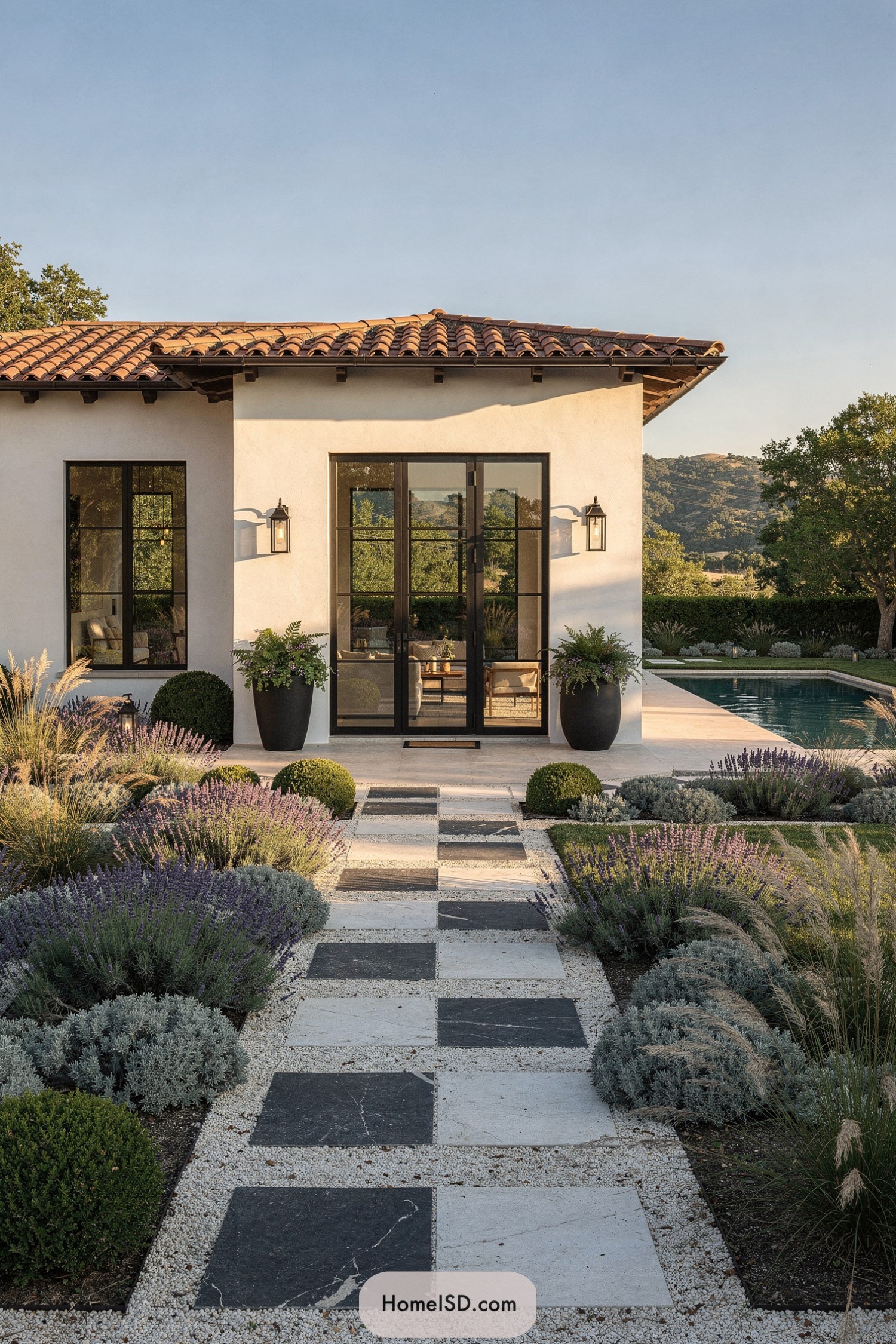 Spanish-style home with checkerboard garden path