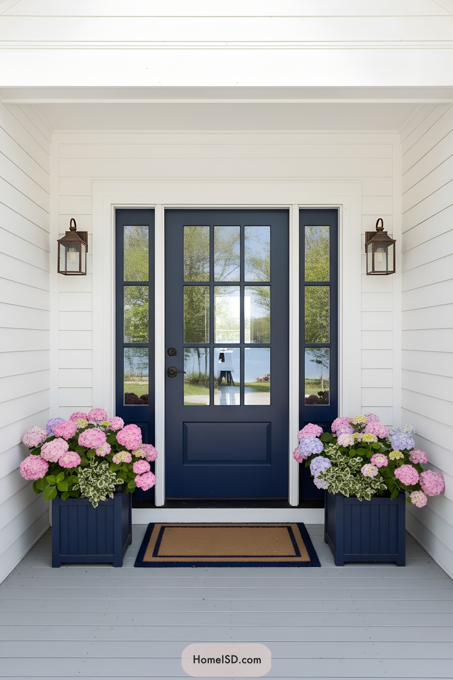 Navy front door with hydrangea planters