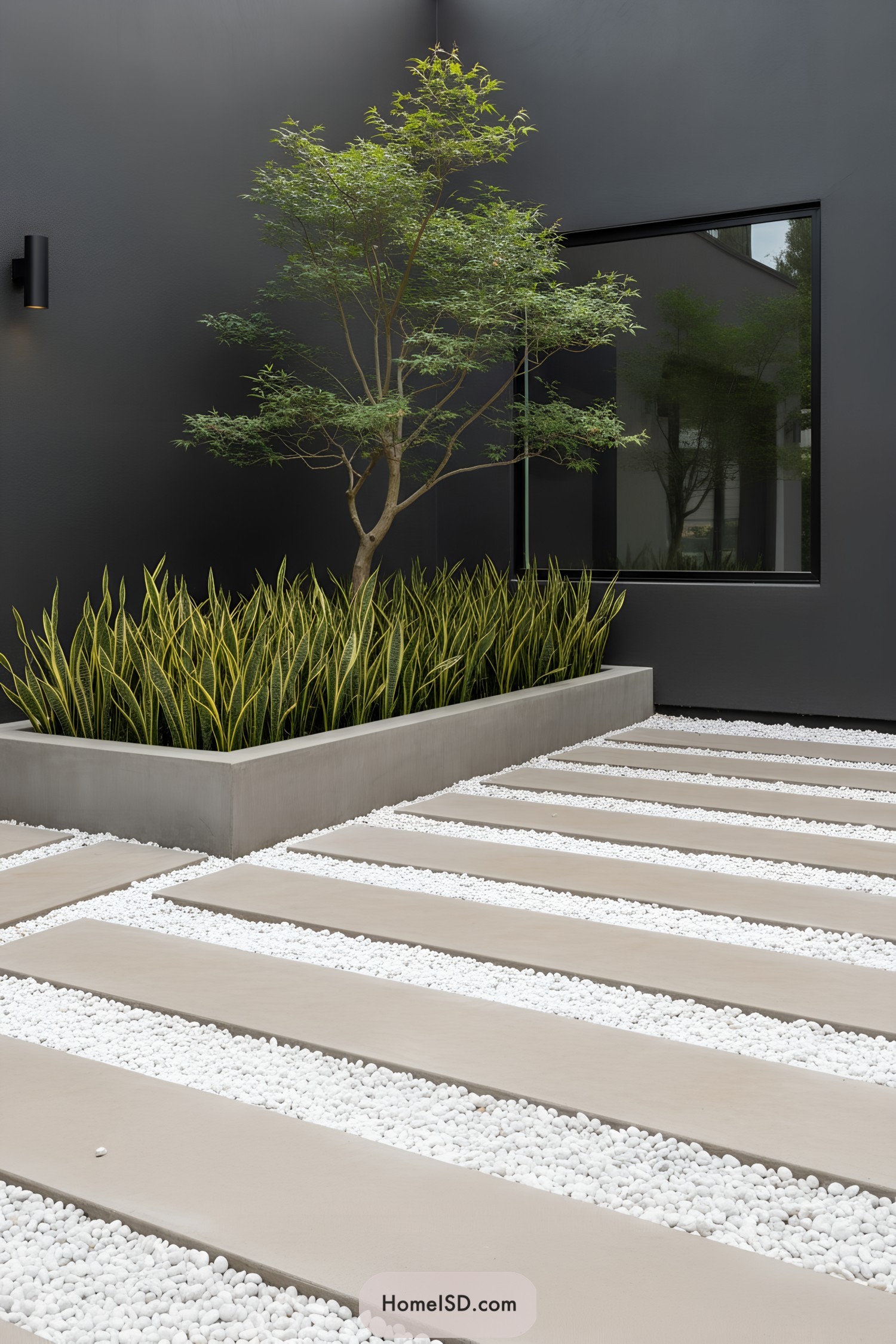 Modern courtyard with white pebble strips and plants